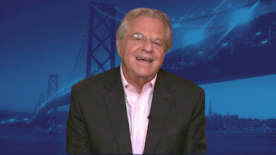 Jerry Springer with blue bridge background