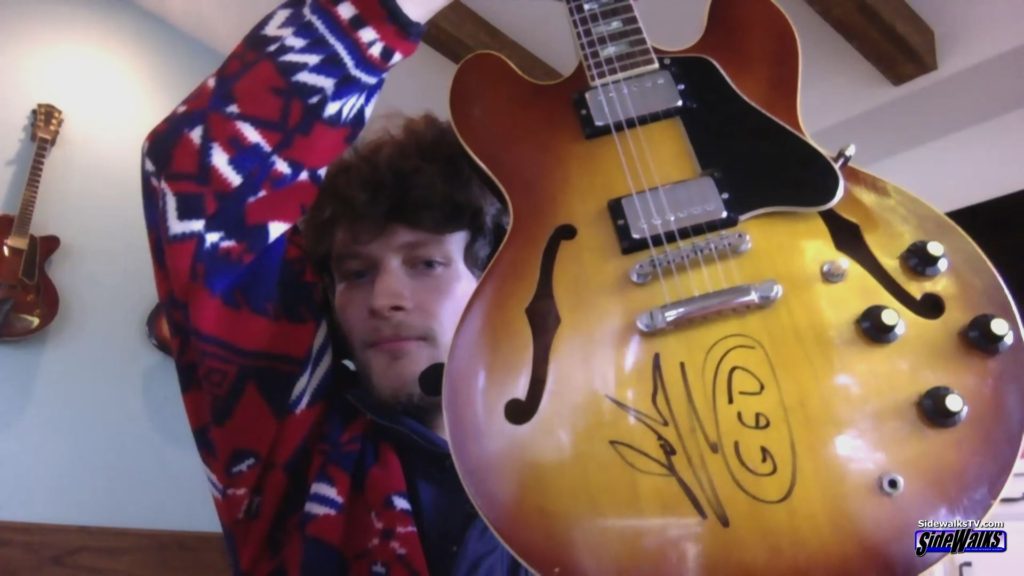 Brett Dier shows his guitar from the Goo Goo Dolls