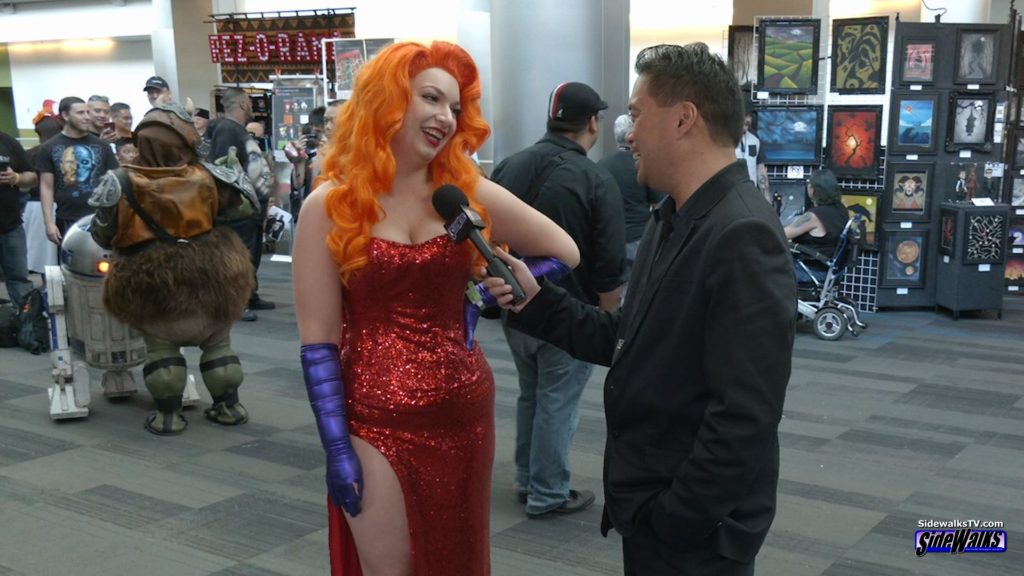 Host Richard R. Lee interviews Jess, dressed as Jessica Rabbit