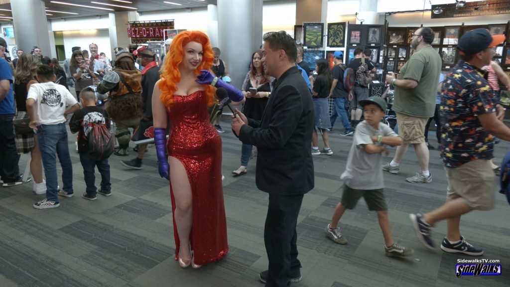 Host Richard R. Lee interviews Jess, dressed as Jessica Rabbit