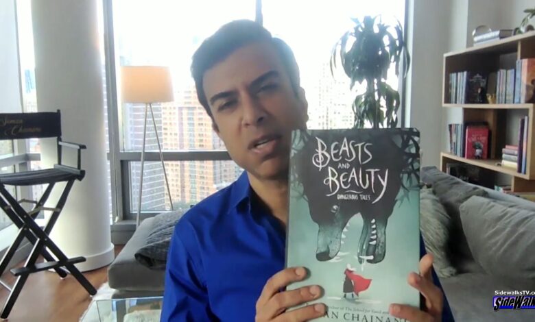 Soman Chainani holds up his latest novel Beasts and Beauty: Dangerous Tales