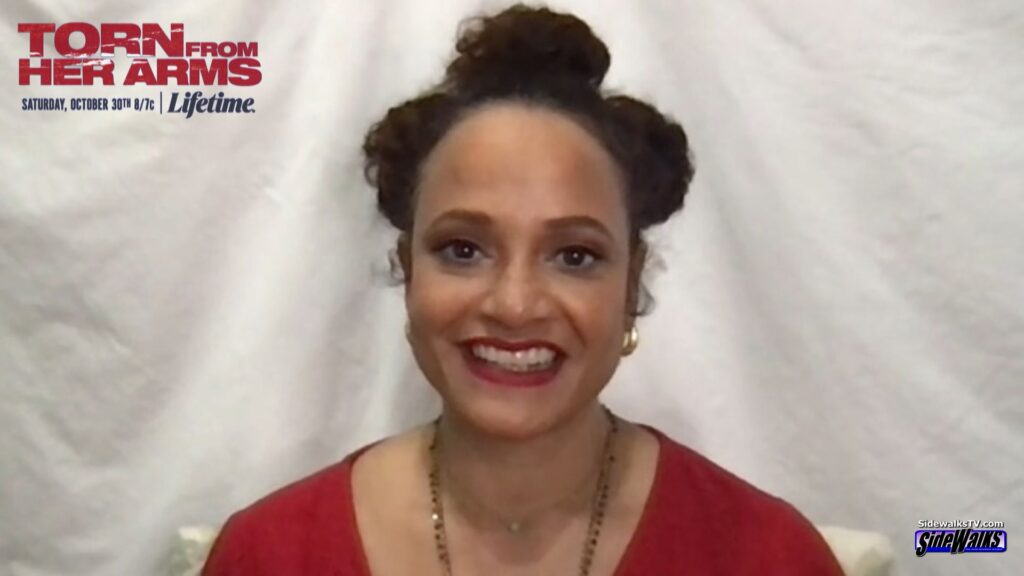 Judy Reyes smiles in a single shot