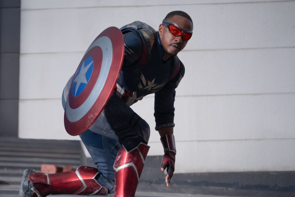 Anthony Mackie as Sam Wilson/Captain America holding his shield in film still.